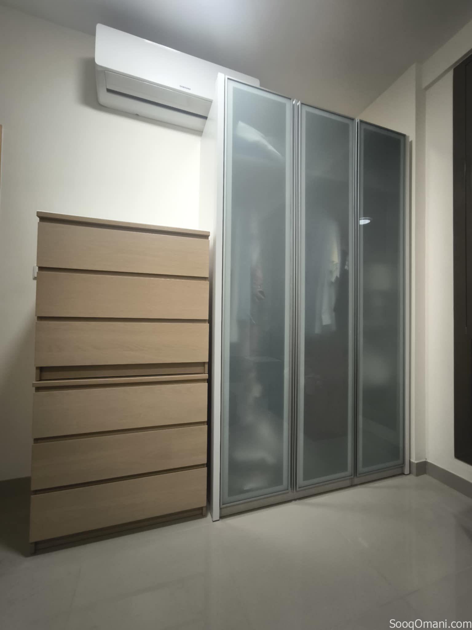 A two-and-a-half-meter-long cabinet made of dusty glass, aluminum, and wood