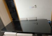 Dining table with glass top and 6 leather chairs