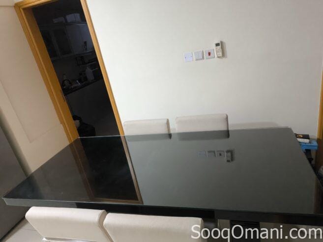 Dining table with glass top and 6 leather chairs
