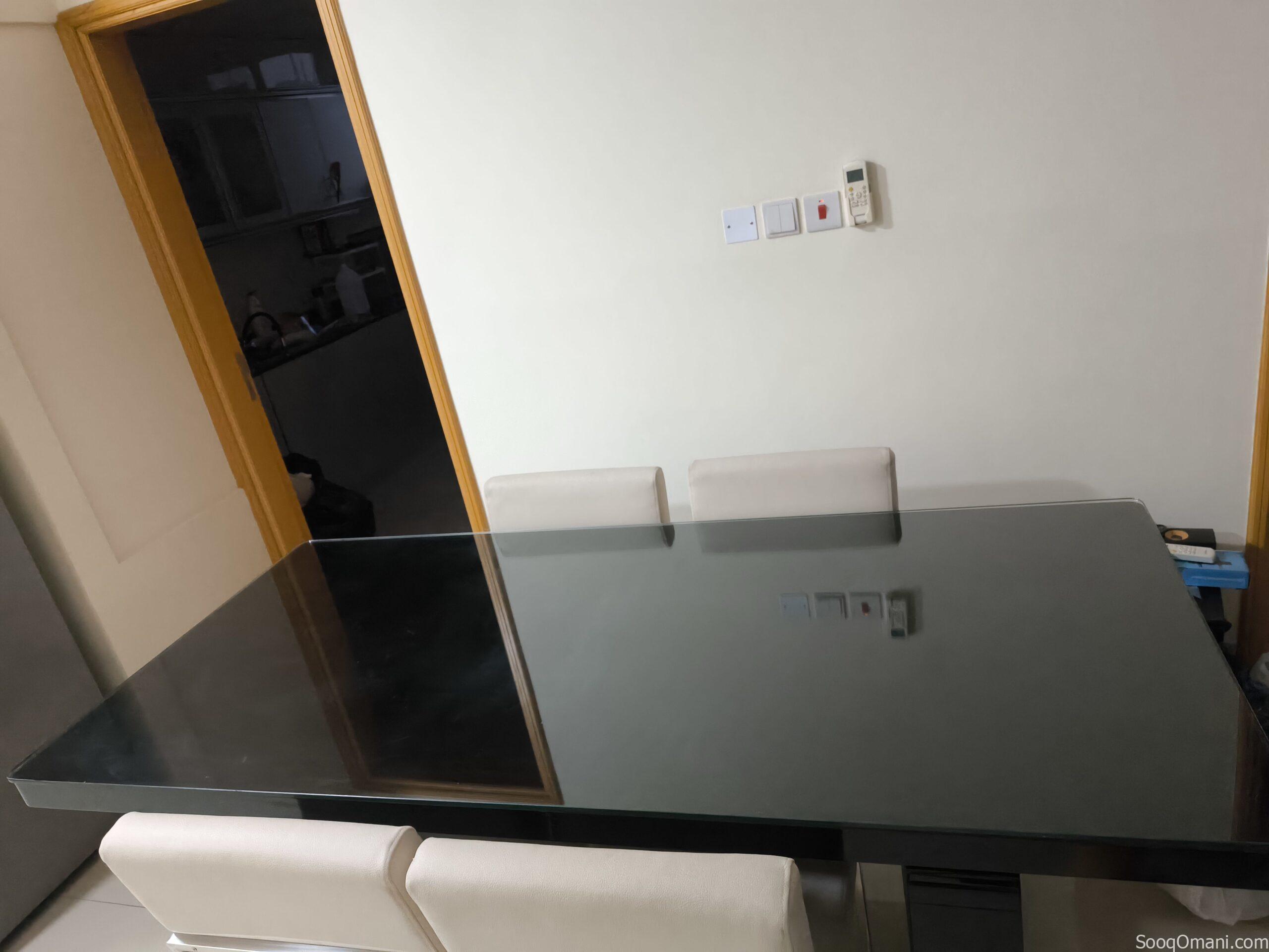 Dining table with glass top and 6 leather chairs