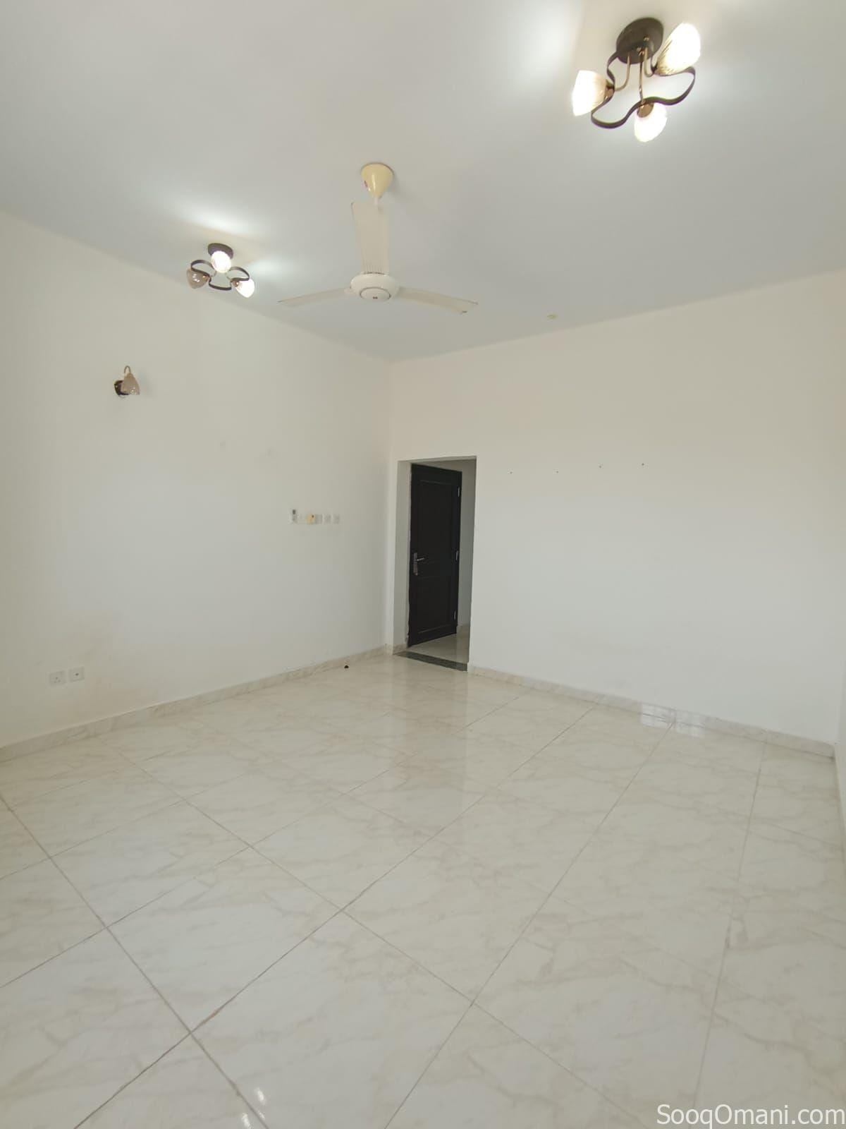 A spacious room designed as a lounge for families, located in Al Mawaleh 11.